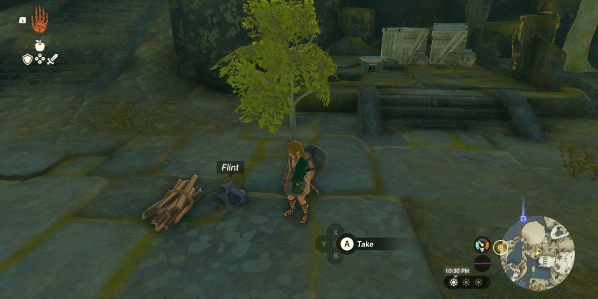 Link fica ao lado de pederneira e madeira em Tears of the Kingdom