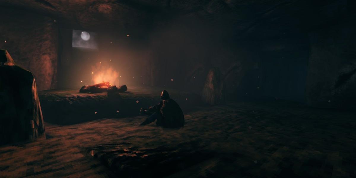 Uma fogueira em uma masmorra de Valheim com um jogador sentado nela.