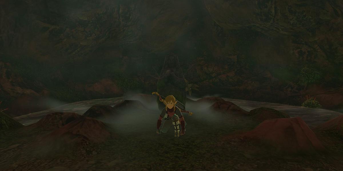 Zelda Tears of the Kingdom - Link agachado na frente da estátua da deusa no poço no estábulo de East Akkala