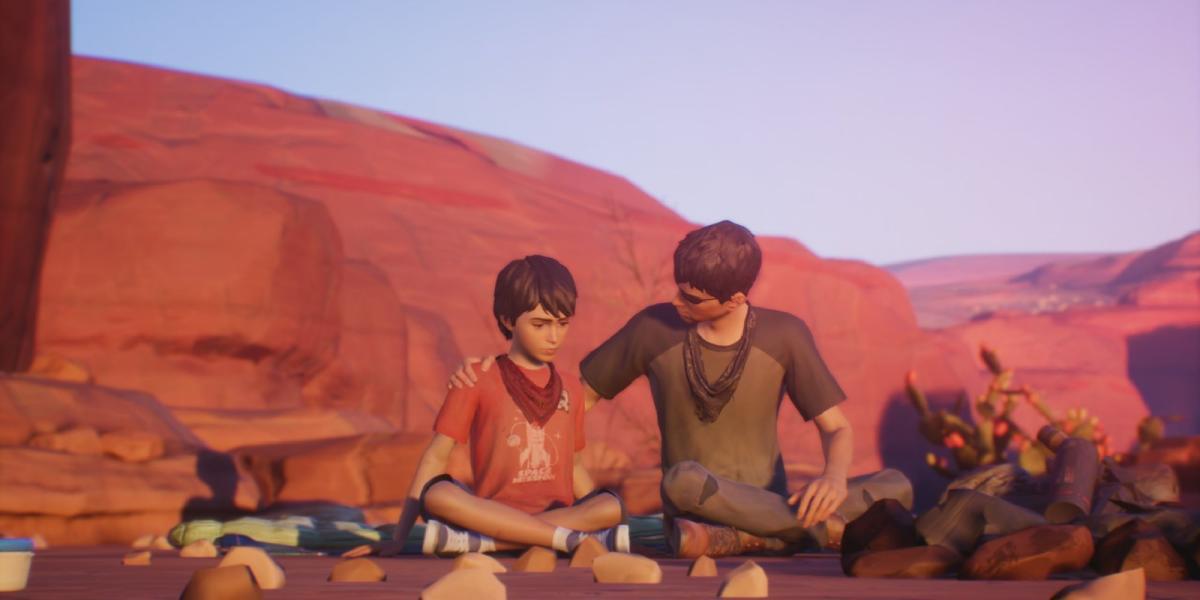 Os dois irmãos de Life is Strange 2 sentados lado a lado no chão, o irmão mais velho confortando o mais novo.