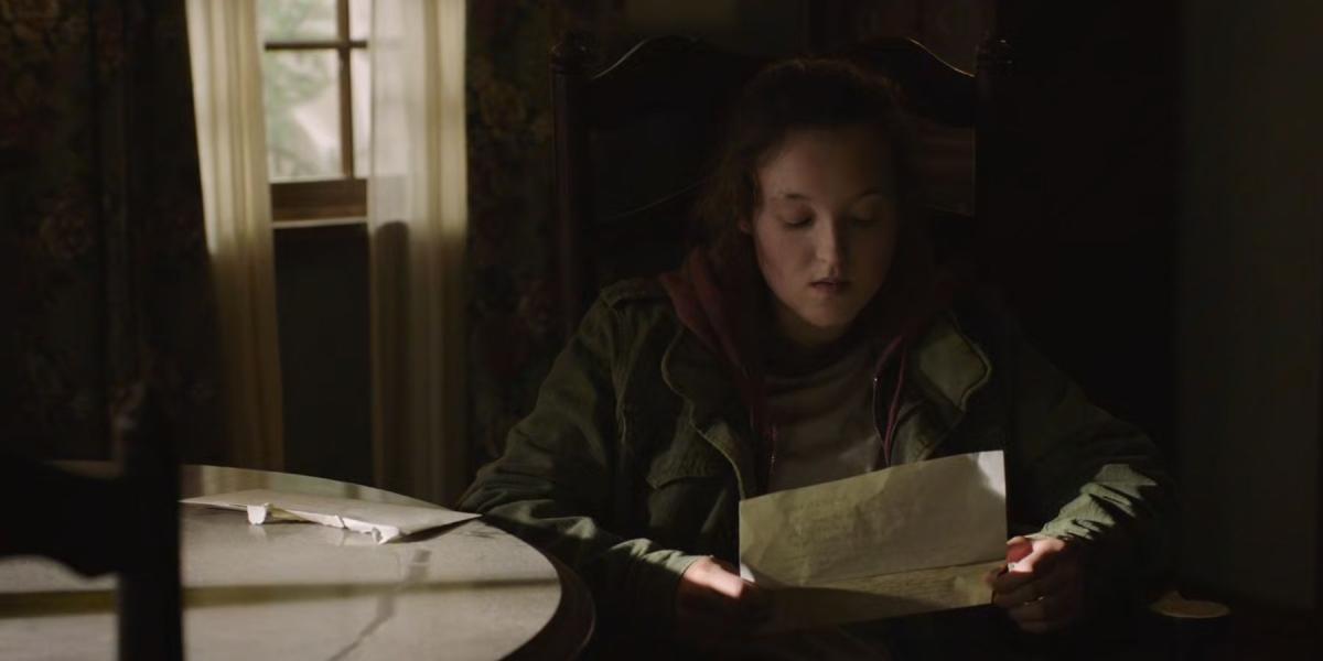 Ellie lendo a carta de Bill para Joel em The Last of Us.