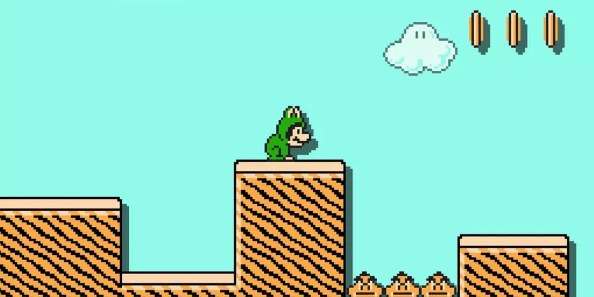 Frog Mario agachado na frente de um poço de Goomba