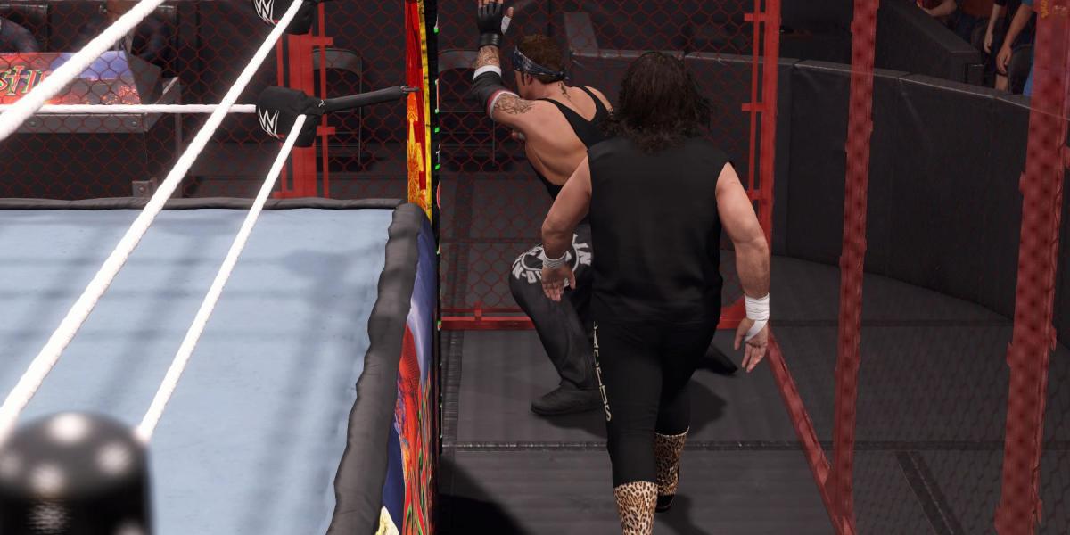 WWE2K23 Undertaker atordoado na parede da cela