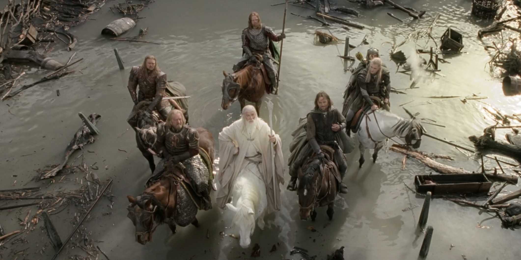 Gandalf and company on horses surrounded by water and debris