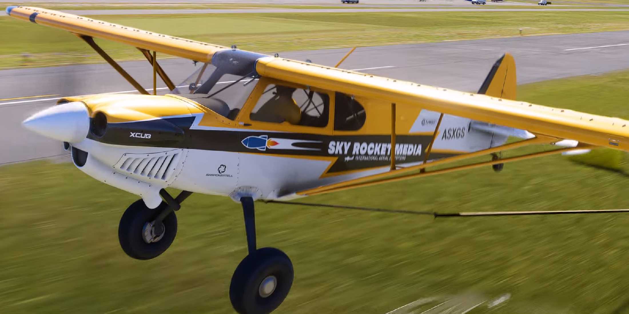 A screenshot from Microsoft Flight Simulator 2024's reveal trailer, showing the aerial advertising plane.