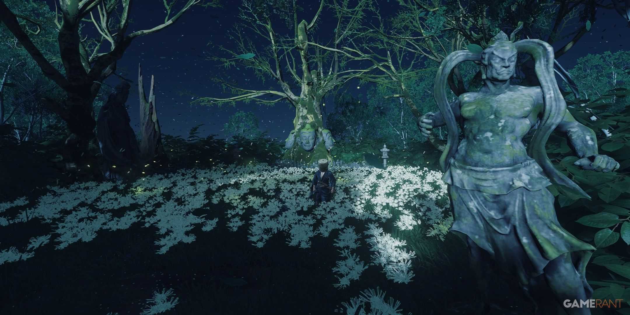 a statue at the entrance of a grove covered with white flowers under the night sky