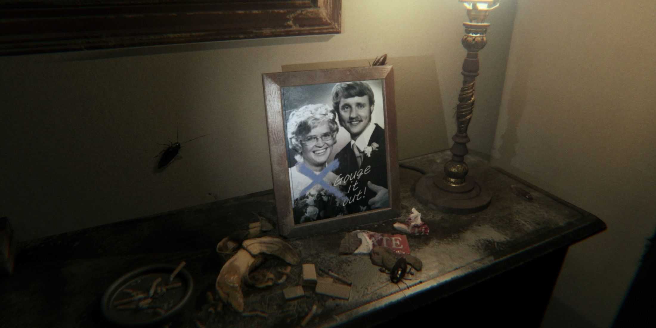 A framed photo of a married couple sitting on a dirty dresser