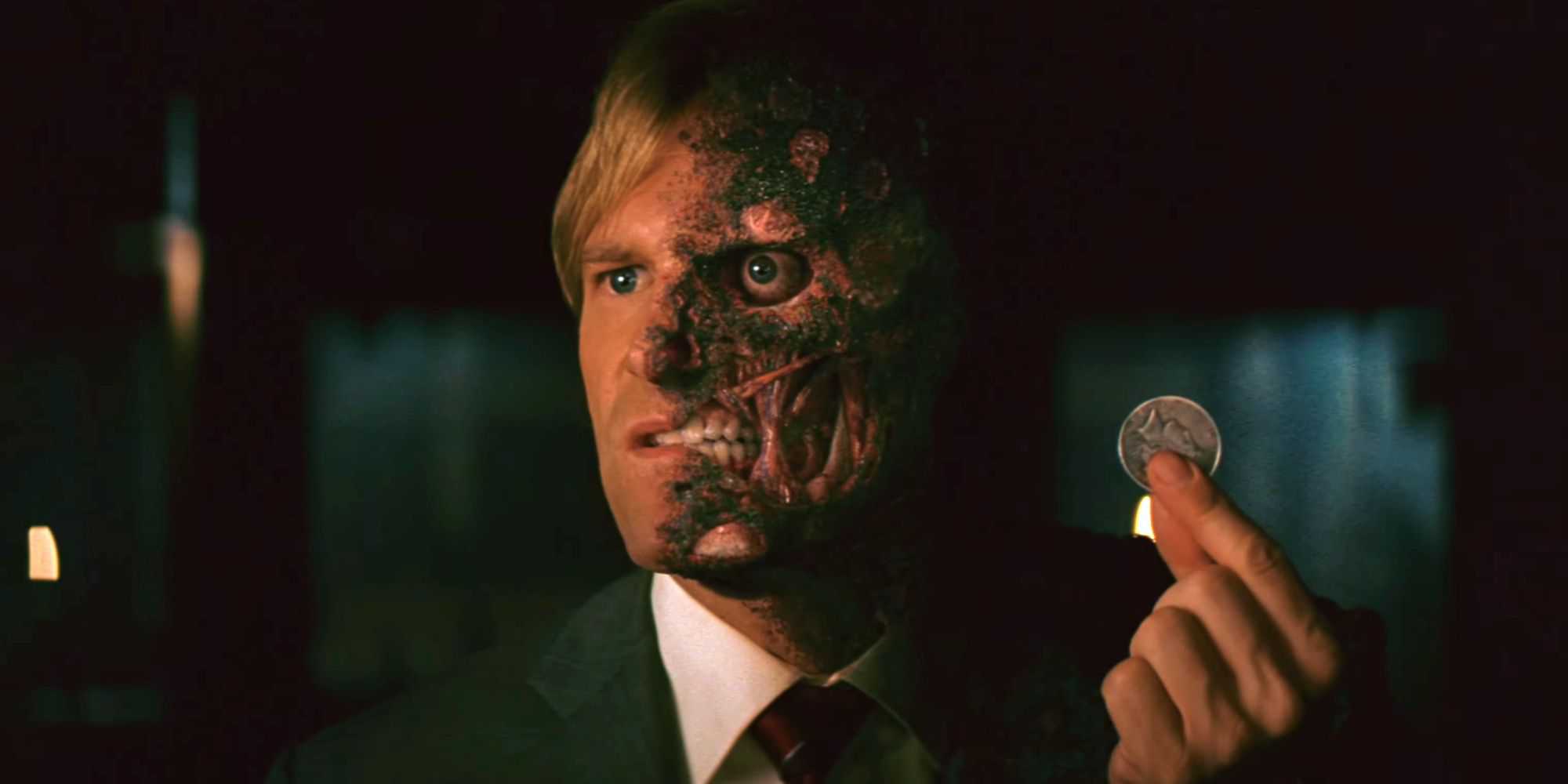 Two-Face holding his coin in The Dark Knight