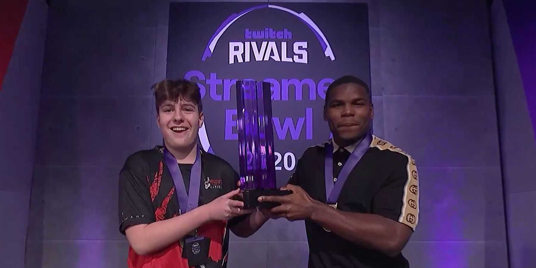 Twitch streamers Tarikcohen and Clix holding up a trophy at a Twitch Rivals event