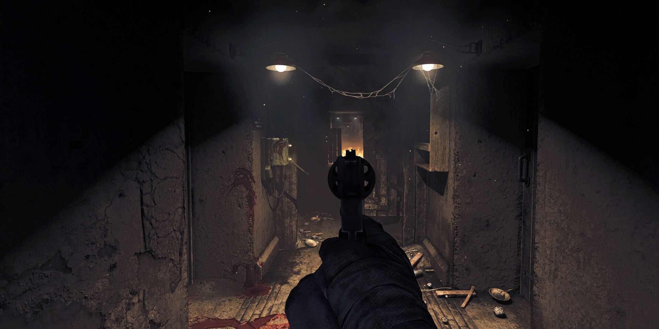 The player aiming a revolver down a long, vandalized corridor