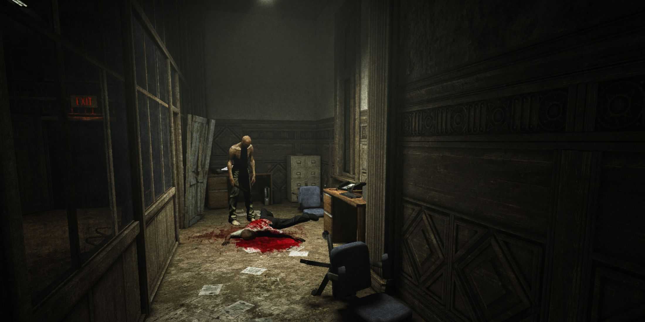 A man stands over a dead body in an office hallway