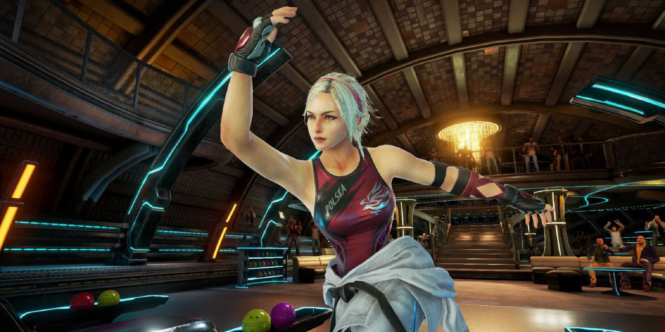 Lidia Sobieska from Tekken 7 is seen in an action pose, wearing a red and black athletic outfit with 'POLSKA' on the chest, set in a futuristic indoor arena.