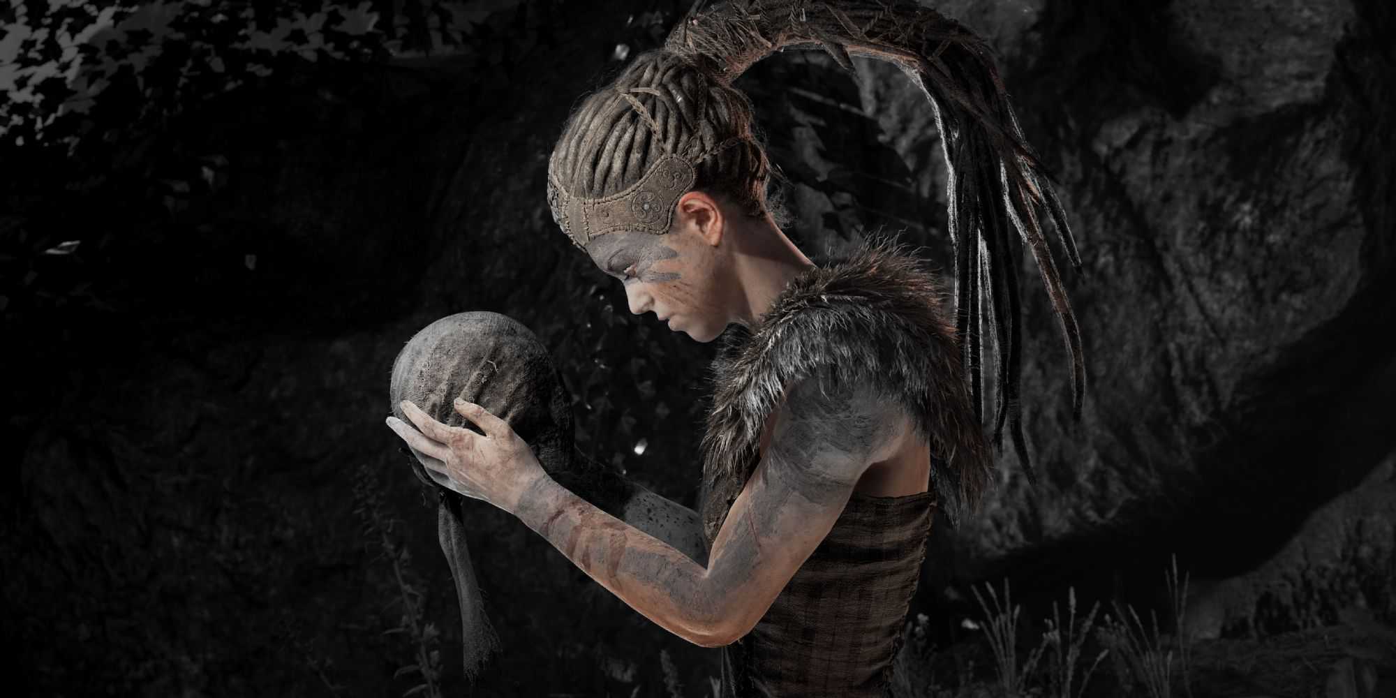 Senua holding Dillion's head in Hellblade: Senua's Sacrifice