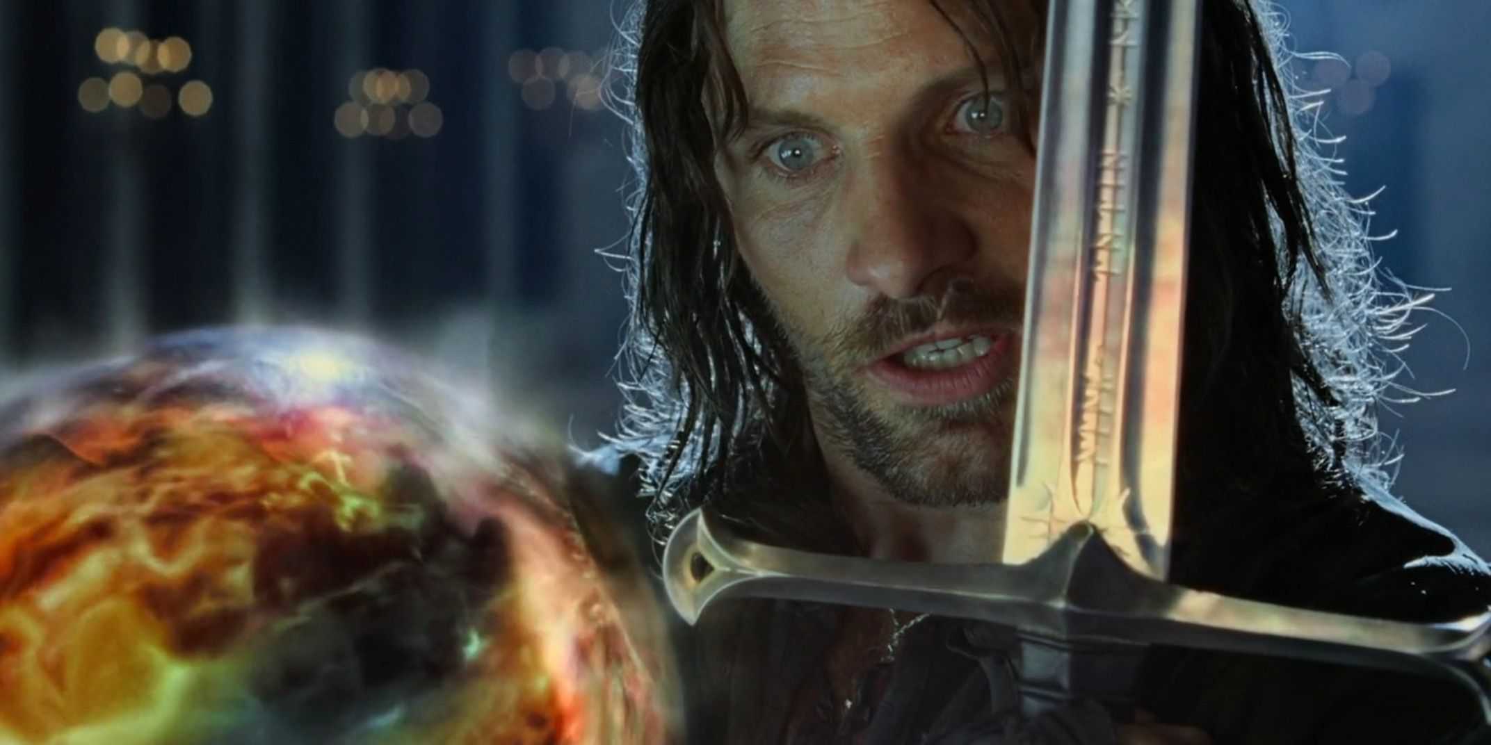 Aragorn holding a sword in front of the palantir