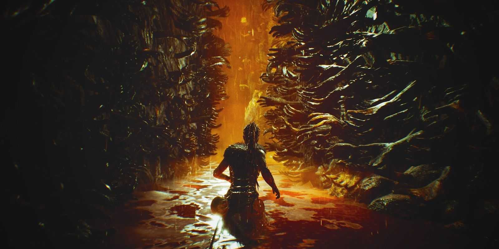 Senua walking between walls of dark arms in The Sea of Corpses, in Hellblade: Senua's Sacrifice