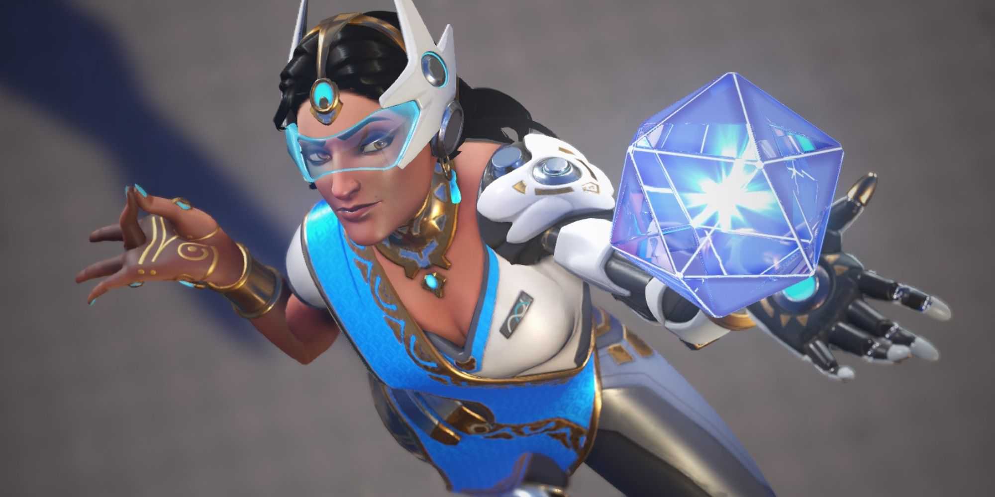 Symmetra from Overwatch 2 holds a hard light construct in her hand.