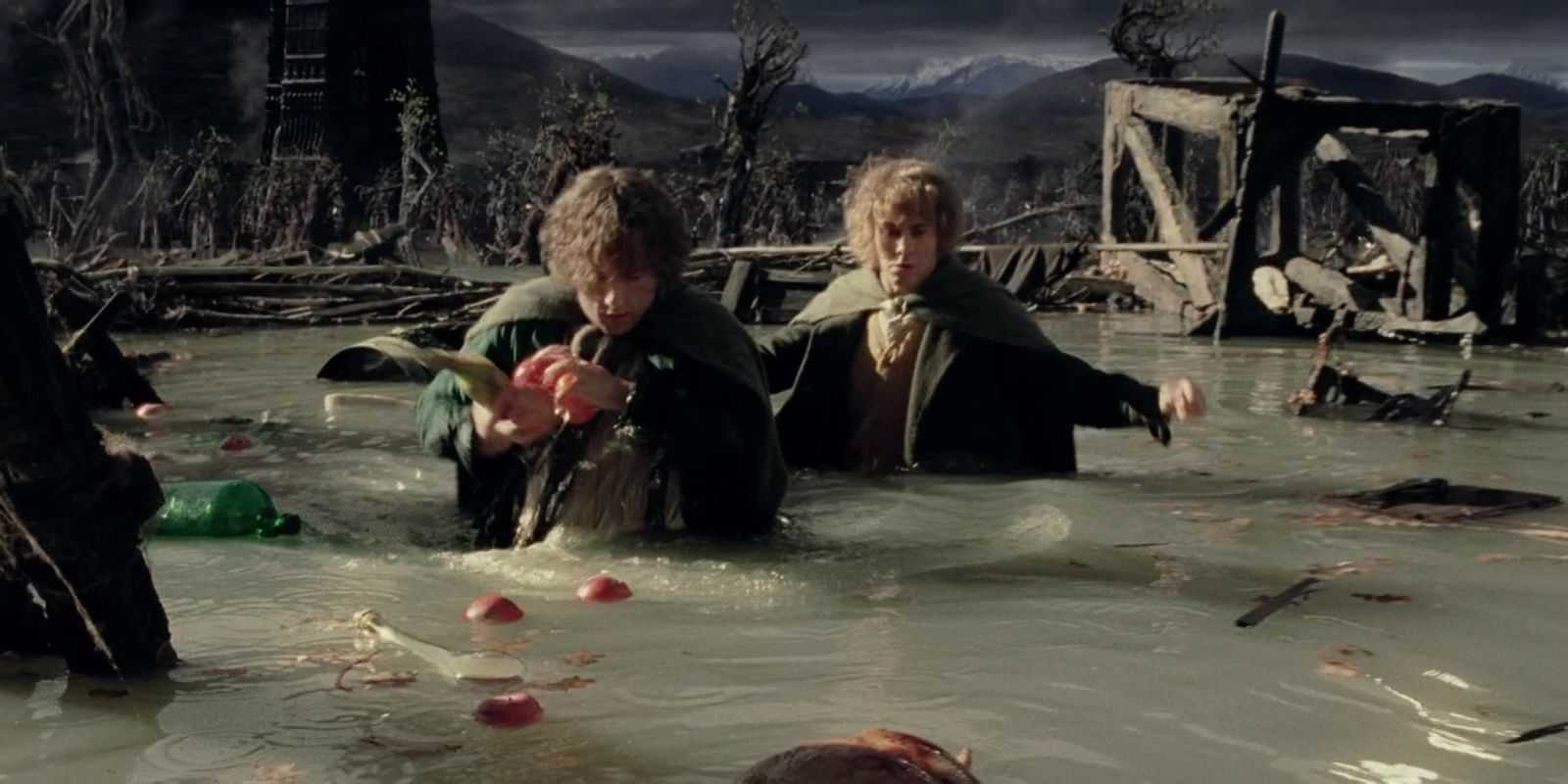 Merry and Pippin wading through the water picking up apples