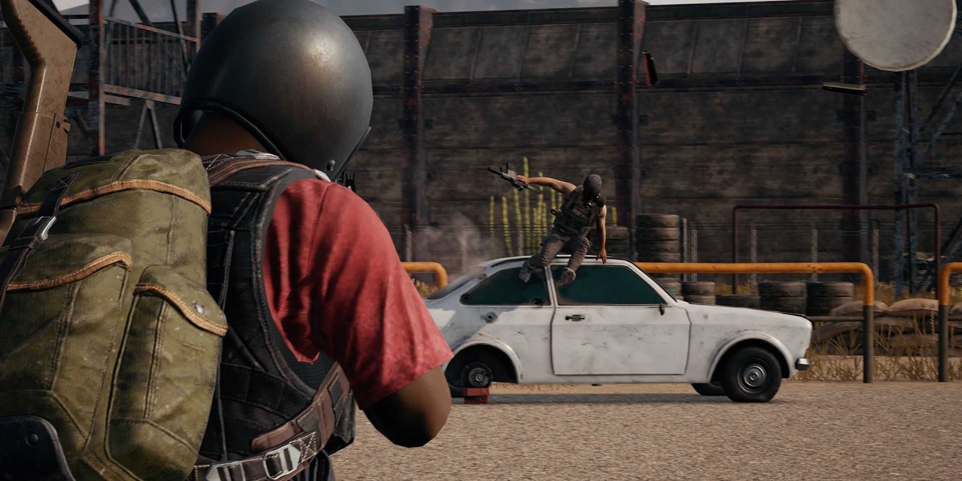 A player jumping over a car in PUBG