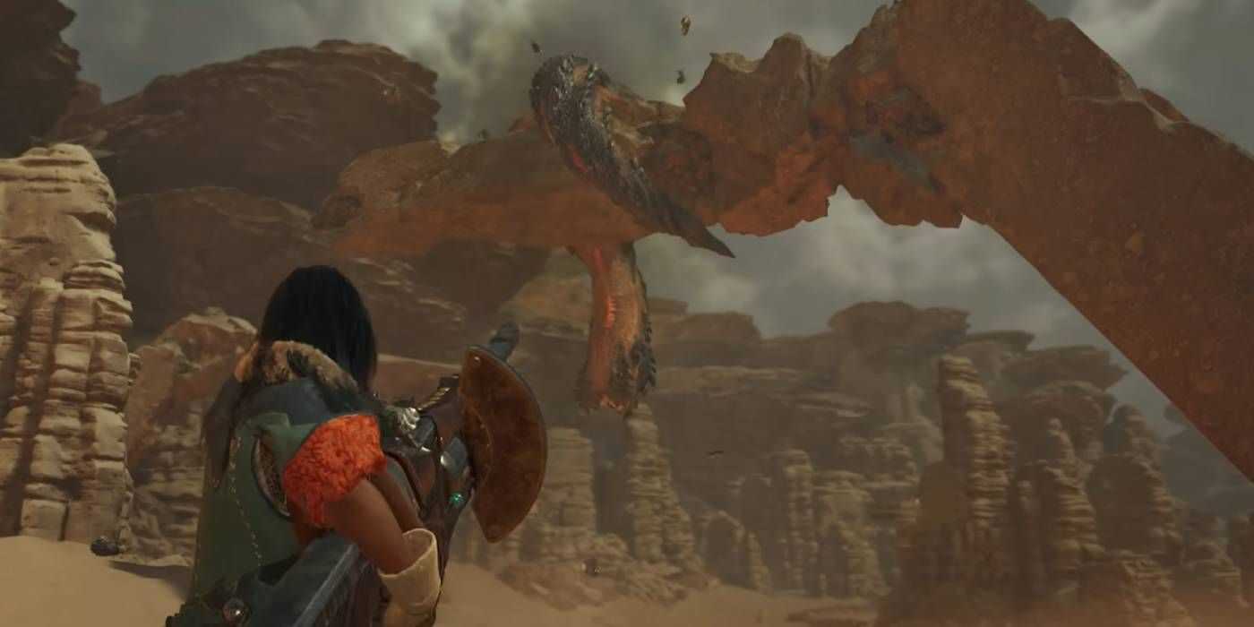 A hunter firing a bowgun at a monster on an arch in Monster hunter Wilds