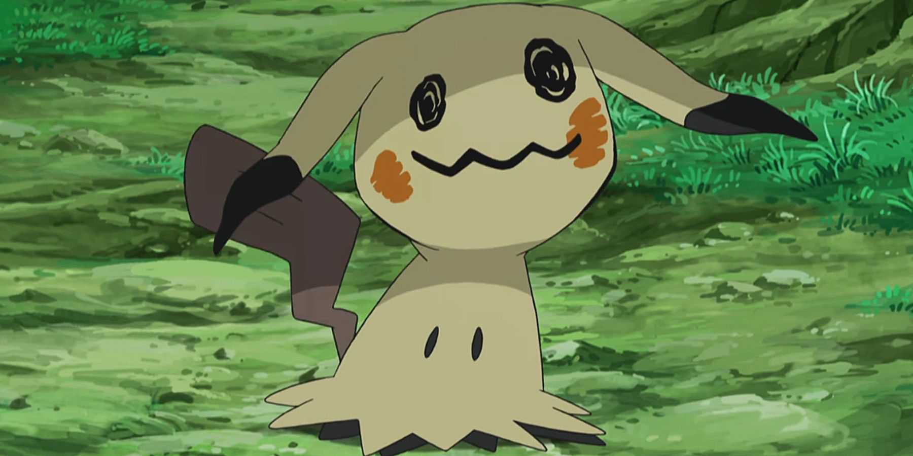 A screenshot of Mimikyu standing near grass in the Pokemon anime.