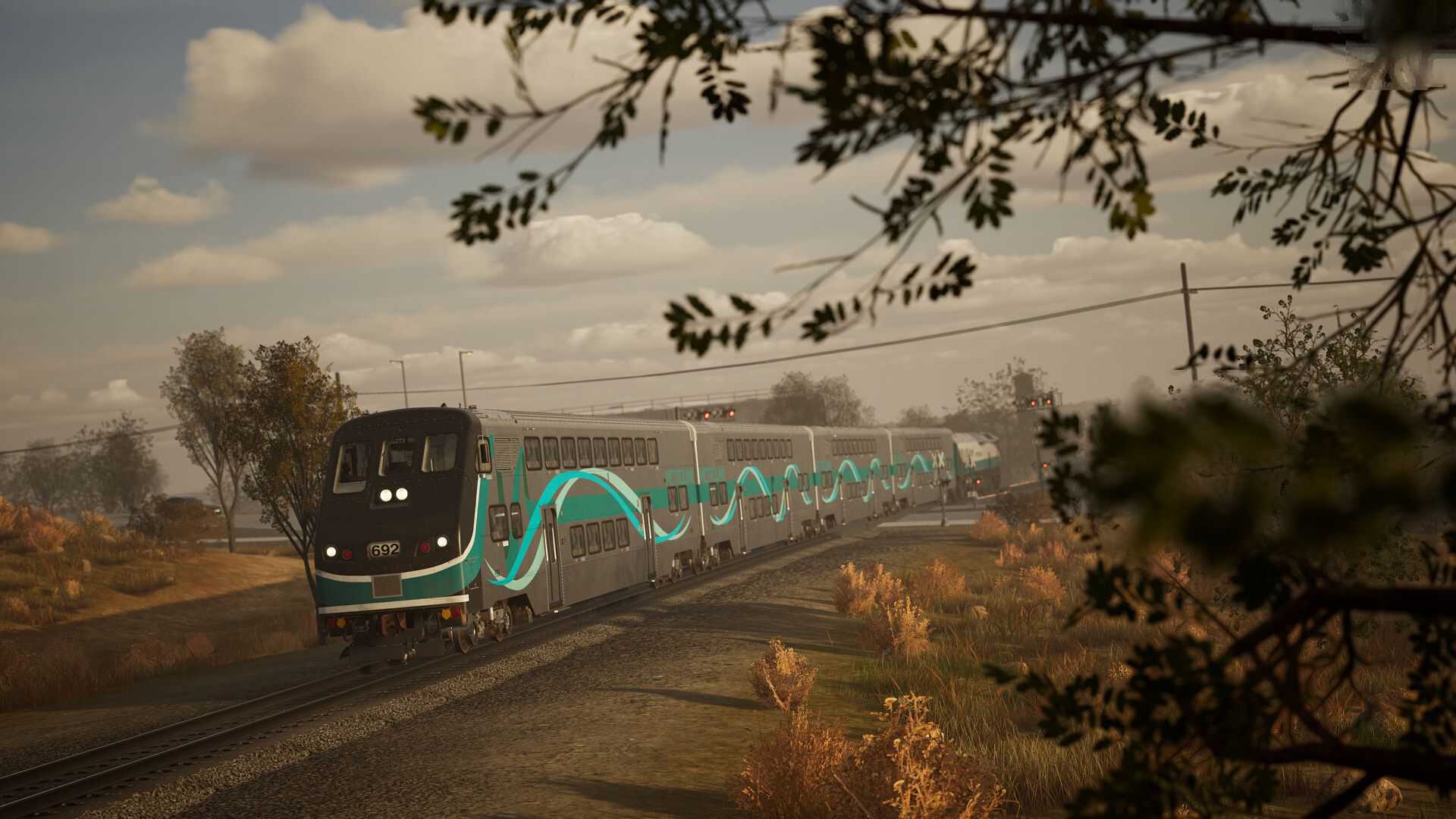 Train Sim World 4 Steam screenshot 5 black train with funky teal pattern driving through countryside during overcast weather