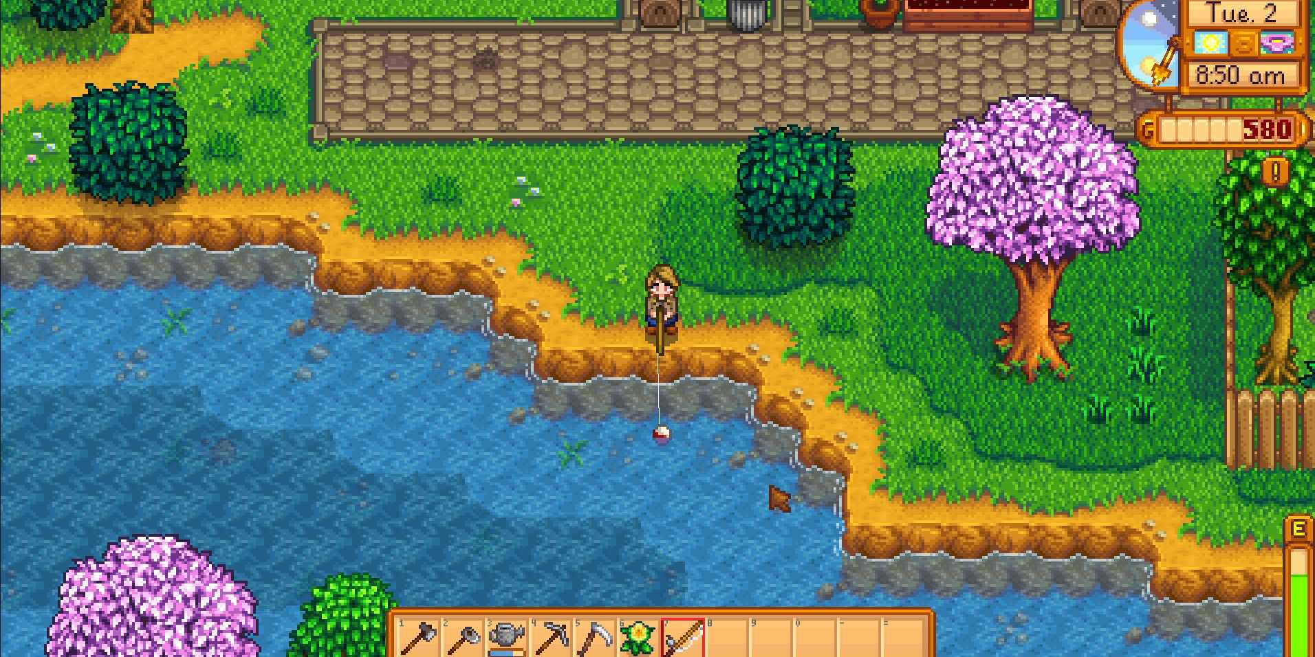 Imagem de um personagem pescando no rio Pelican Town em Stardew Valley