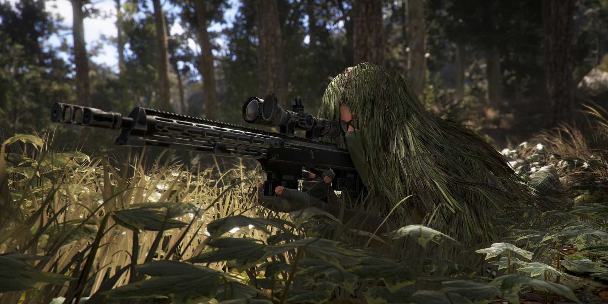 A person in a Ghillie suit lying in the grass with a sniper rifle in Tom Clancy's Ghost Recon Wildlands