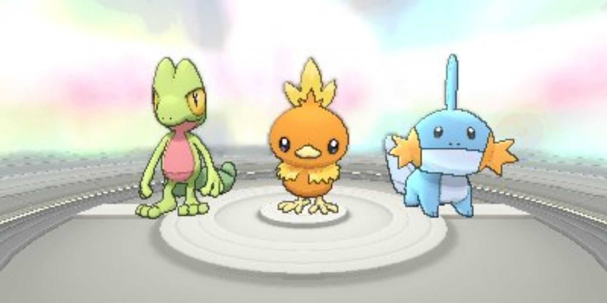 Hoenn starter Pokemon Treecko, Torchic, and Mudkip stand in a line.