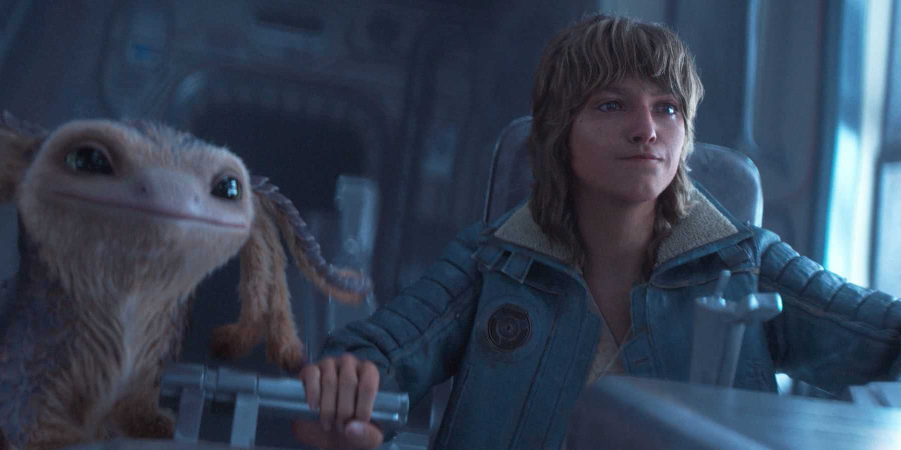 A screenshot of Kay Vess and Nix in the cockpit of thier spaceship in Star Wars Outlaws.